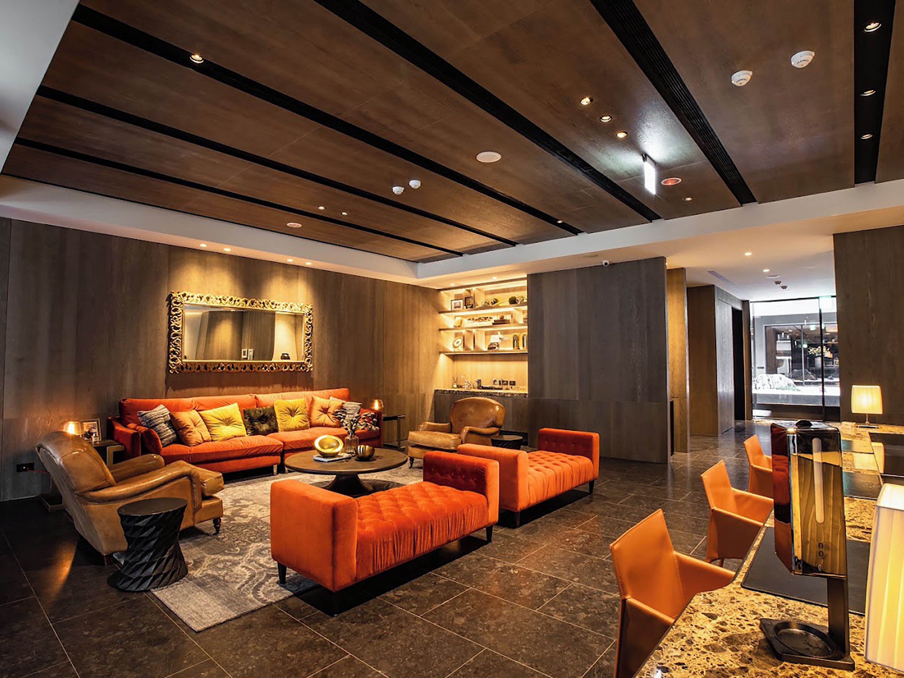A modern living room with a sofa set, armchairs, a coffee table, and a fireplace.