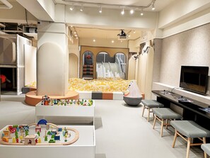 A modern interior with a play area, seating, and a television. - CHECK inn SELECT Chiayi RenAi (Chiayi City)