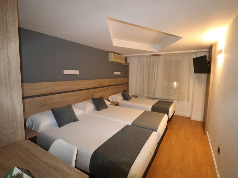 Triple Room | Desk, blackout drapes, iron/ironing board, free WiFi