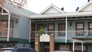 A building with a sign reading "Red Mountain House" and "Bed & Breakfast Self-Catering Accommodation." - Red Mountain House (Clarens)