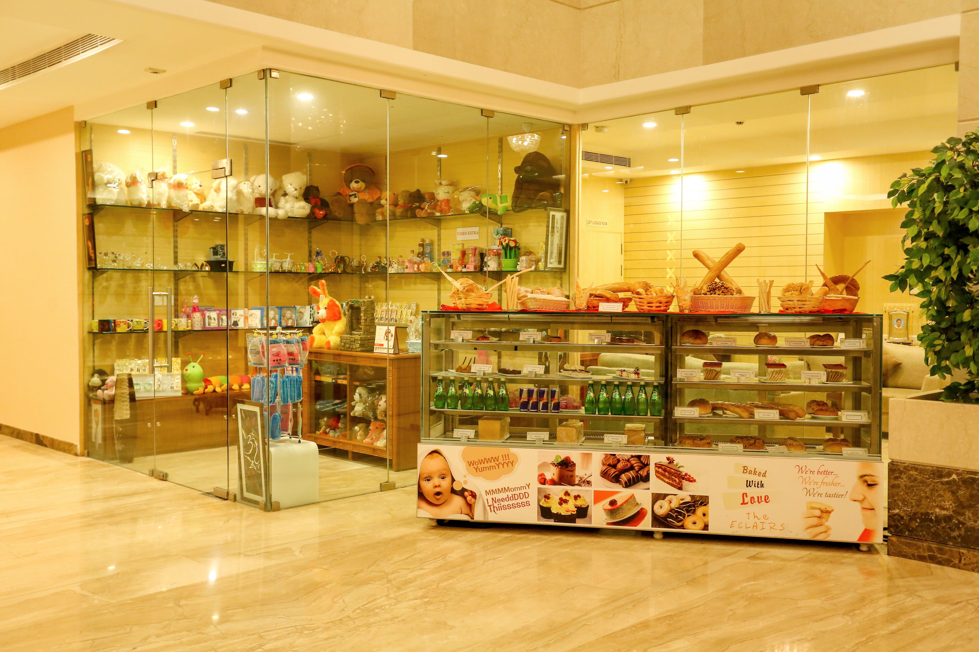 A bakery display with various baked goods and a glass-fronted toy store.