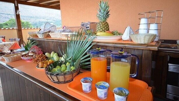 A breakfast buffet with fruits, juices, and condiments. - Baia Santa Margherita B&B (San Vito Lo Capo)