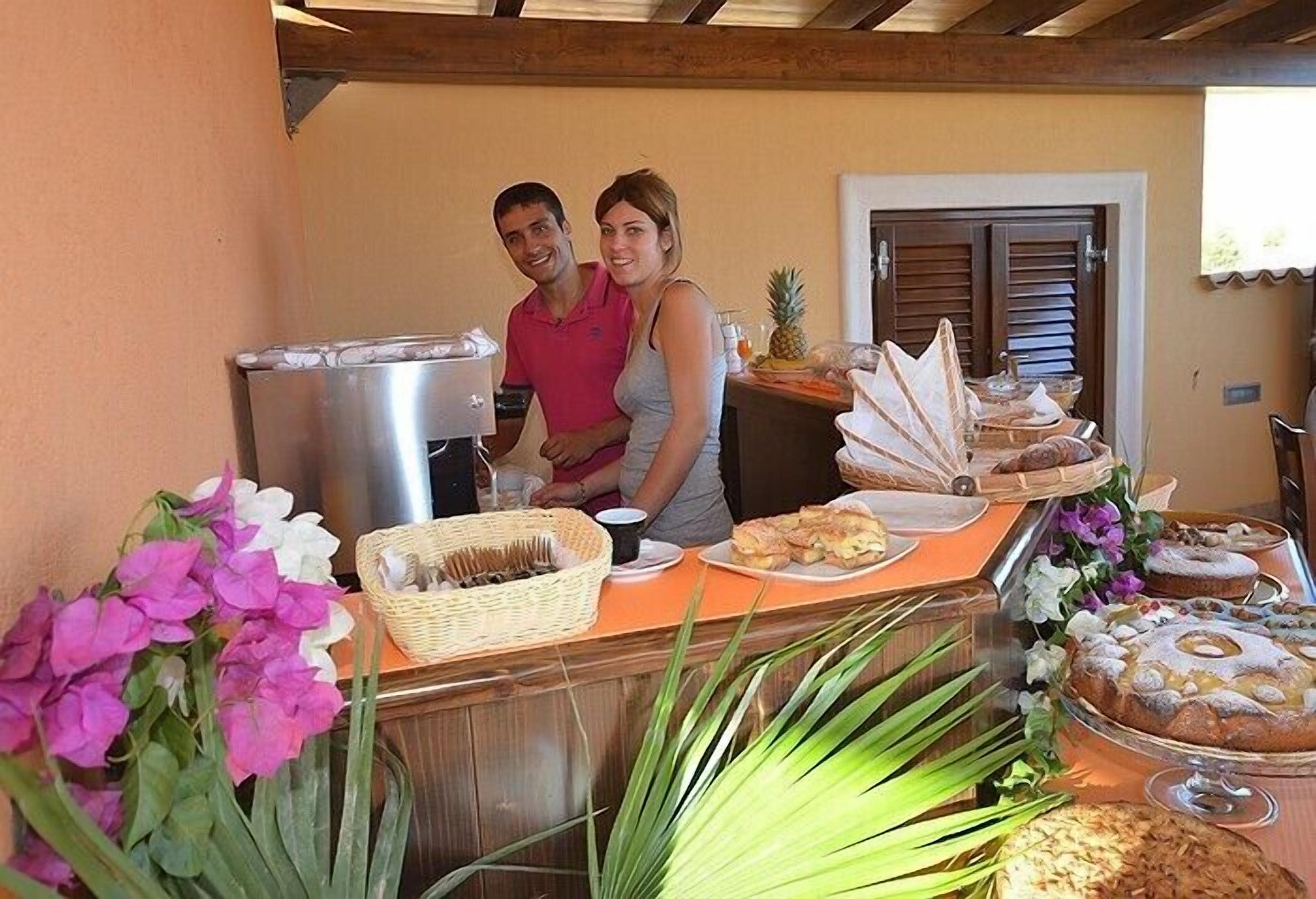 A buffet setup with various food items and a coffee machine.