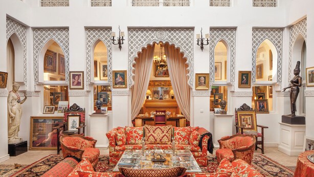 A traditional room with ornate decor, including a sofa set, a chandelier, and framed artwork. - Dar El Mudal - Adults Only (Marrakech)
