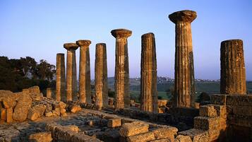Ancient stone columns and ruins, likely part of a historical site.