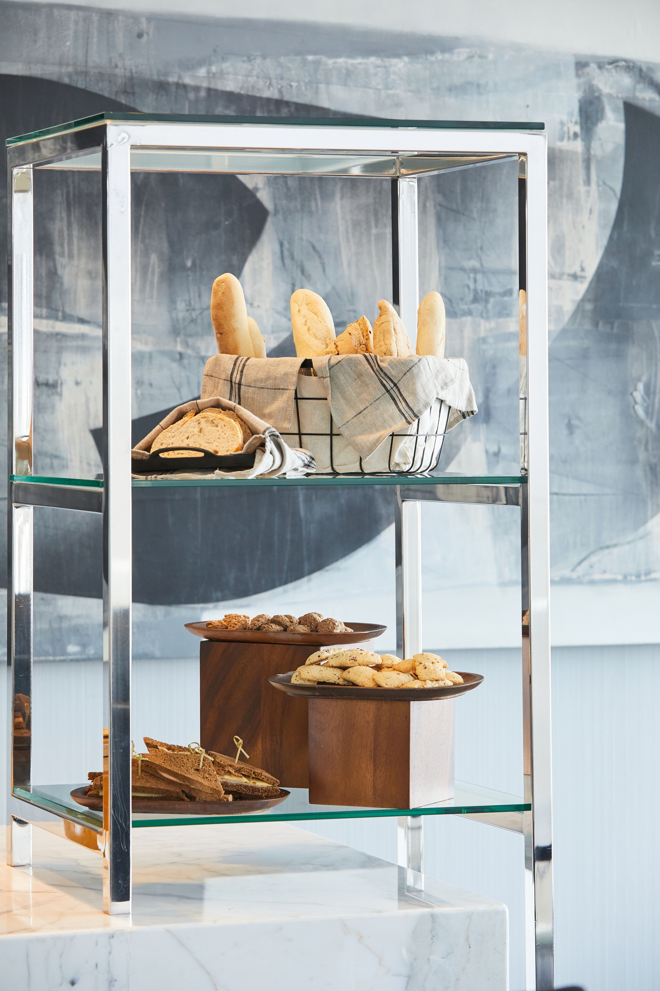 A glass display case with bread and pastries.