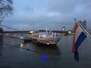 A boat docked at a port with a bridge in the background. - KNM MS Switzerland II - Frankfurt (Frankfurt)