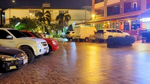A parking area with several cars and a delivery truck. - Rayong Lanna Hotel (Rayong)