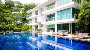 A modern hotel with a pool, multiple balconies, and lush greenery. - Presidential Penhouse - Kamala (Kamala)