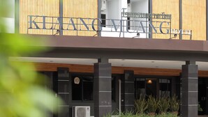 Exterior del HOTEL KELANG MUANG con un diseño moderno, que destaca un letrero prominente y un área de entrada cubierta.
