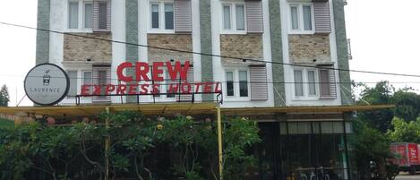 A multi-story hotel with a sign reading "CREW EXPRESS HOTEL".