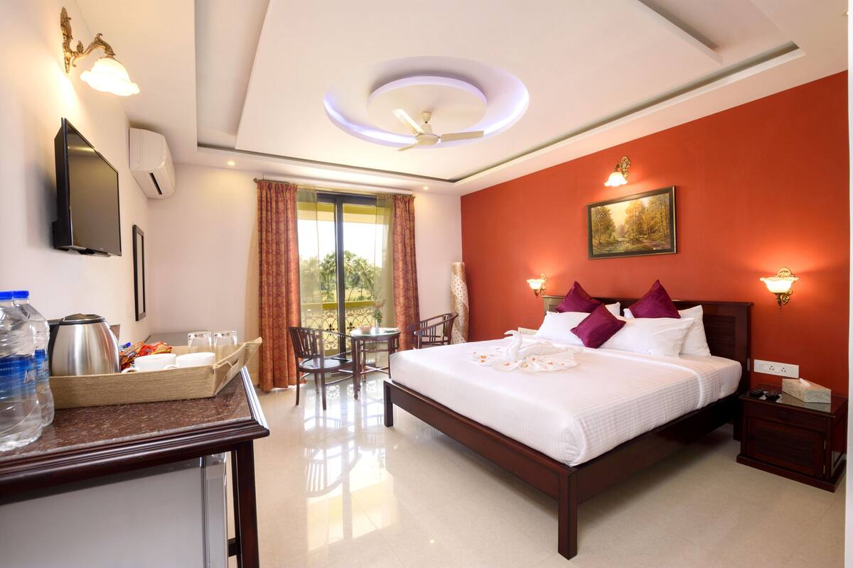 deluxe double room, 1 king bed, garden view, garden area | beach/ocean view