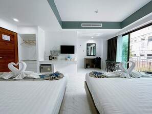 A hotel room with two beds, a desk, a TV, and a balcony with a view. - Machorat Aonang Resort (Krabi)