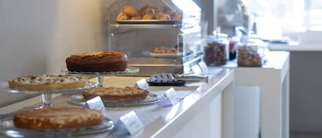 A bakery display with various baked goods in clear containers.
