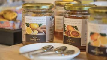 Jars of marmalade on a table with spoons.