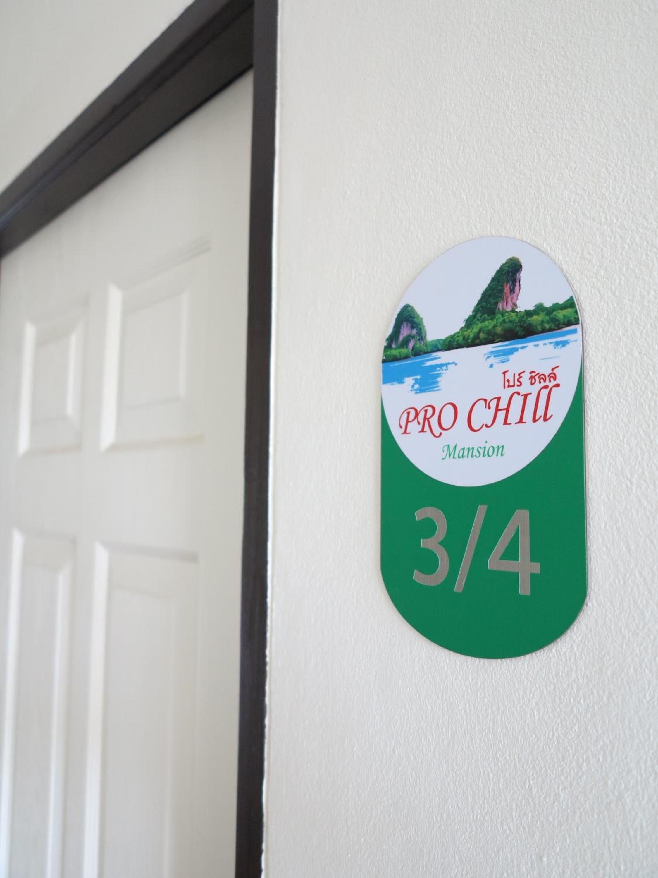 A door with a sign indicating room number 3/4 at Pro Chilli Mansion.