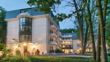 A multi-story hotel with a modern design, featuring balconies and large windows.