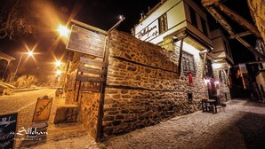 A stone building with a sign reading "Sillachan Hotel Restaurant & Cafe" at night. - Sillehan Boutique Hotel (Konya)