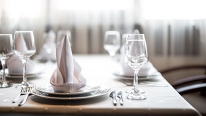 A neatly set dining table with plates, glasses, and cutlery. - Kopala Tskneti (Tbilisi)