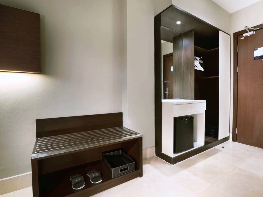 A modern bathroom with a large mirror, a sink, and a dark wood vanity.