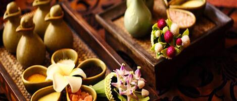 A tray with various items including small vases, bowls, and flowers, suggesting a spa or relaxation setting.
