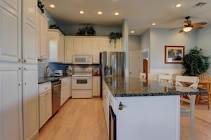 Enjoy cooking in this well-equipped kitchen with oven, microwave, and refrigerator.