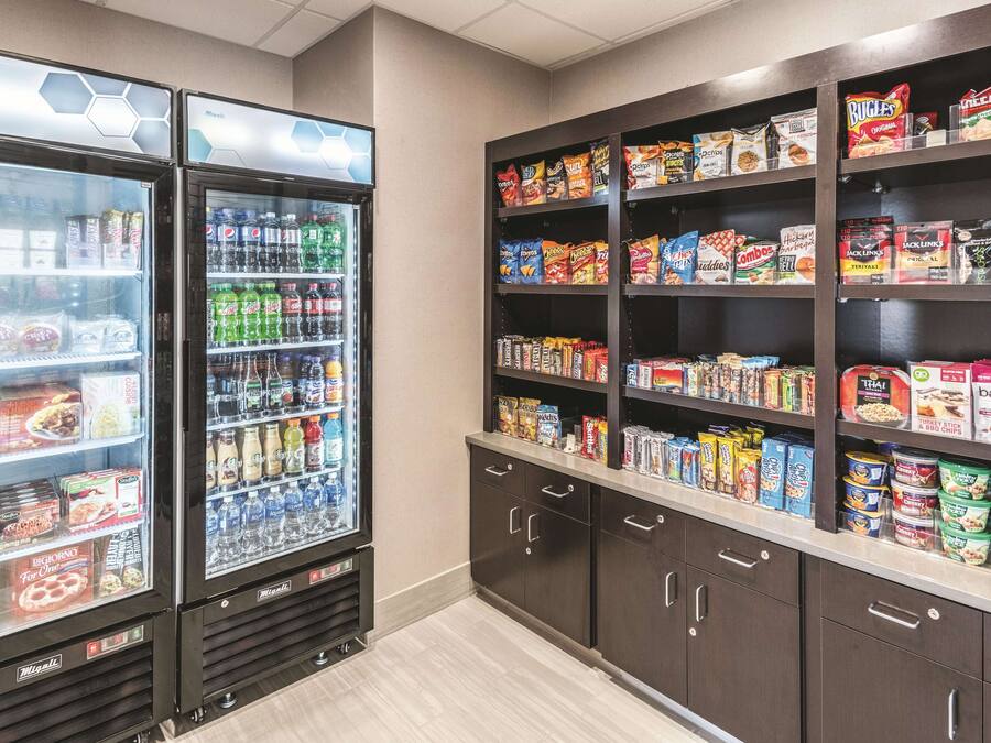 A vending area with a variety of snacks and drinks, including microwavable meals and bottled beverages.
