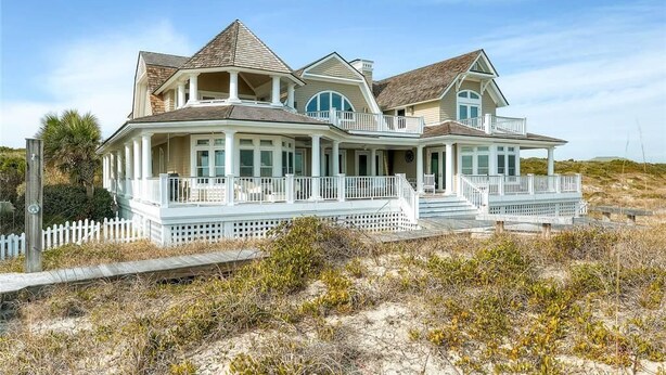 A large, two-story beachfront house with multiple balconies and a covered porch area. - Loggerhead Lady 4 Bedroom Holiday Home By Bald Head Island (Bald Head Island)