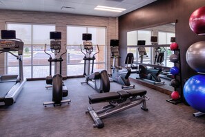 A gym with treadmills, elliptical machines, and exercise balls. - Courtyard by Marriott Detroit Farmington (Farmington Hills)