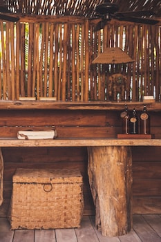 Situated in a serene outdoor space, this bench offers a cozy spot to rest. at Encantada Tulum