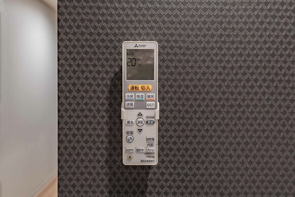 A control panel with a digital display and various buttons for room settings.