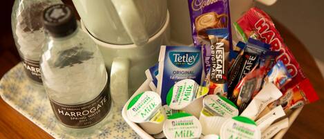 A tray with various food items including milk, chocolate, and snacks.