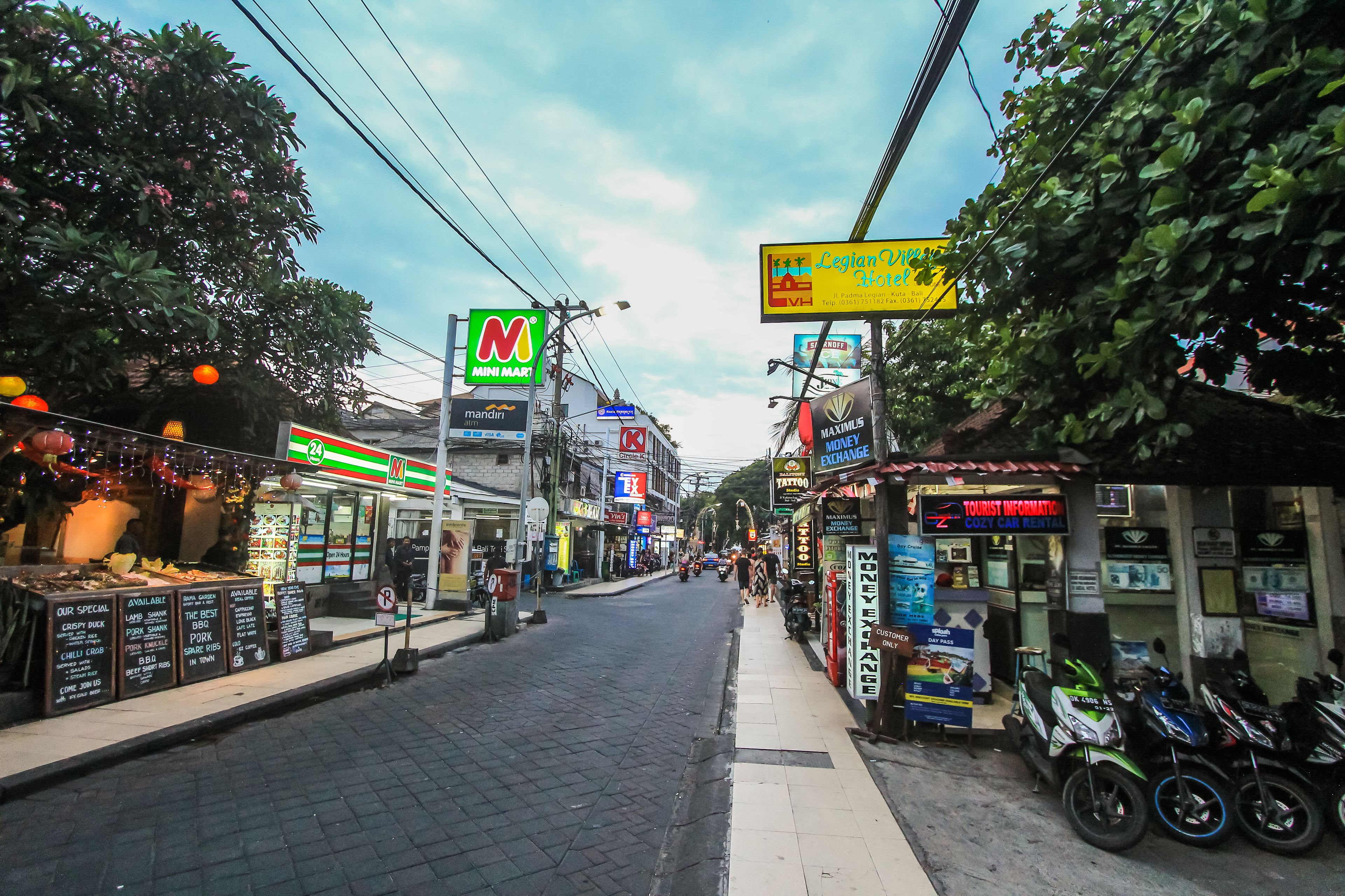 A street with various shops, including a Mini Mart and a tourist information center.