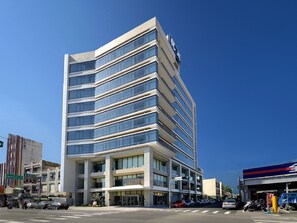 A modern multi-story building with a prominent sign at the top. - The Walden (Yilan)