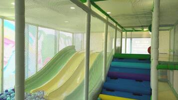 A multi-level play area with slides and a ball pit.