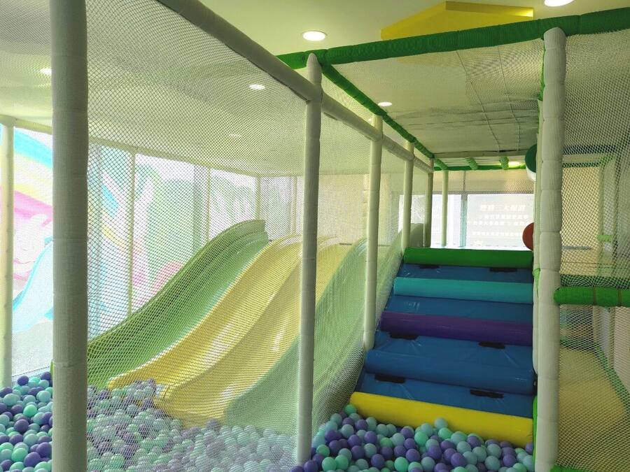 A multi-level play area with slides and a ball pit.