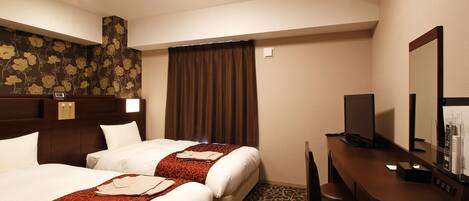 A hotel room with two beds, a desk, a chair, a television, and a control panel.