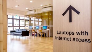 A modern indoor space with a sign indicating 'Laptops with Internet access'. - NARA Visitor Center & Inn (Nara)