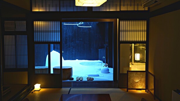 A traditional Japanese room with tatami flooring, a low table, and a sliding door leading to a snow-covered garden. - Kiraku Kyoto Aneyakoji (Kyoto)