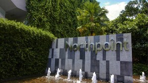 A sign with the name "Northpoint" surrounded by a water feature and lush greenery. - NorthPoint Pattaya Luxury Apartments by GrandisVillas (Pattaya)