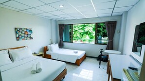 A hotel room with two beds, a desk, a chair, a small table, a TV, and a window with curtains. - Central Place Hotel (Rayong)