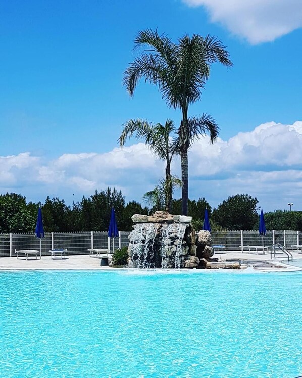 Seasonal outdoor pool, pool umbrellas, pool loungers