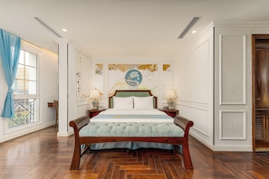 A hotel room with a wooden bed, a large window with curtains, a decorative wall with artwork, and a nightstand with a lamp. - Hanoi Maro Hotel (Hanoi)