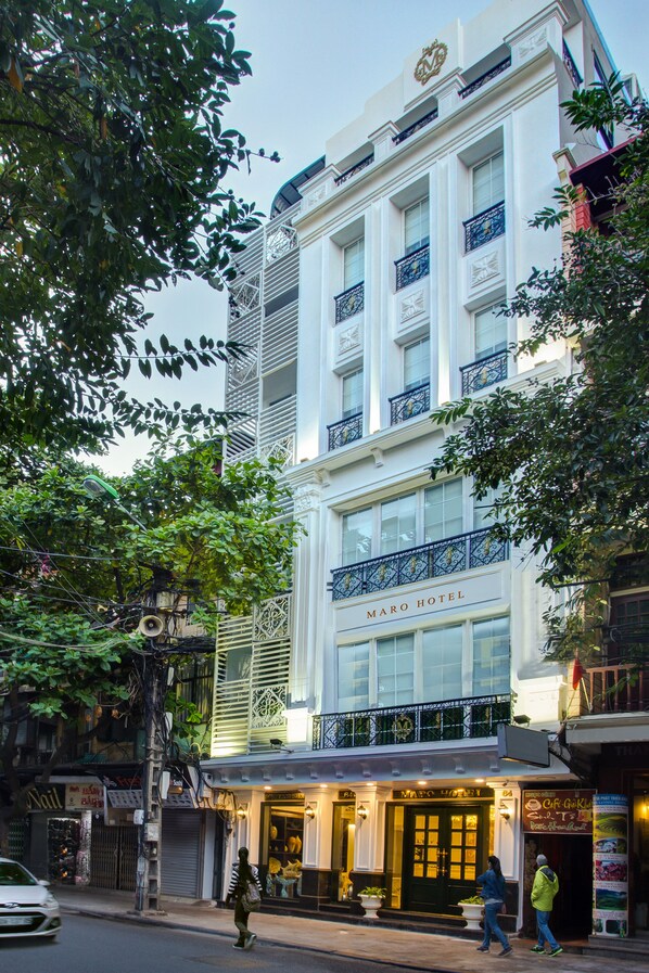 A hotel with a classic facade, large windows, and a prominent entrance. - Hanoi Maro Hotel (Hanoi)