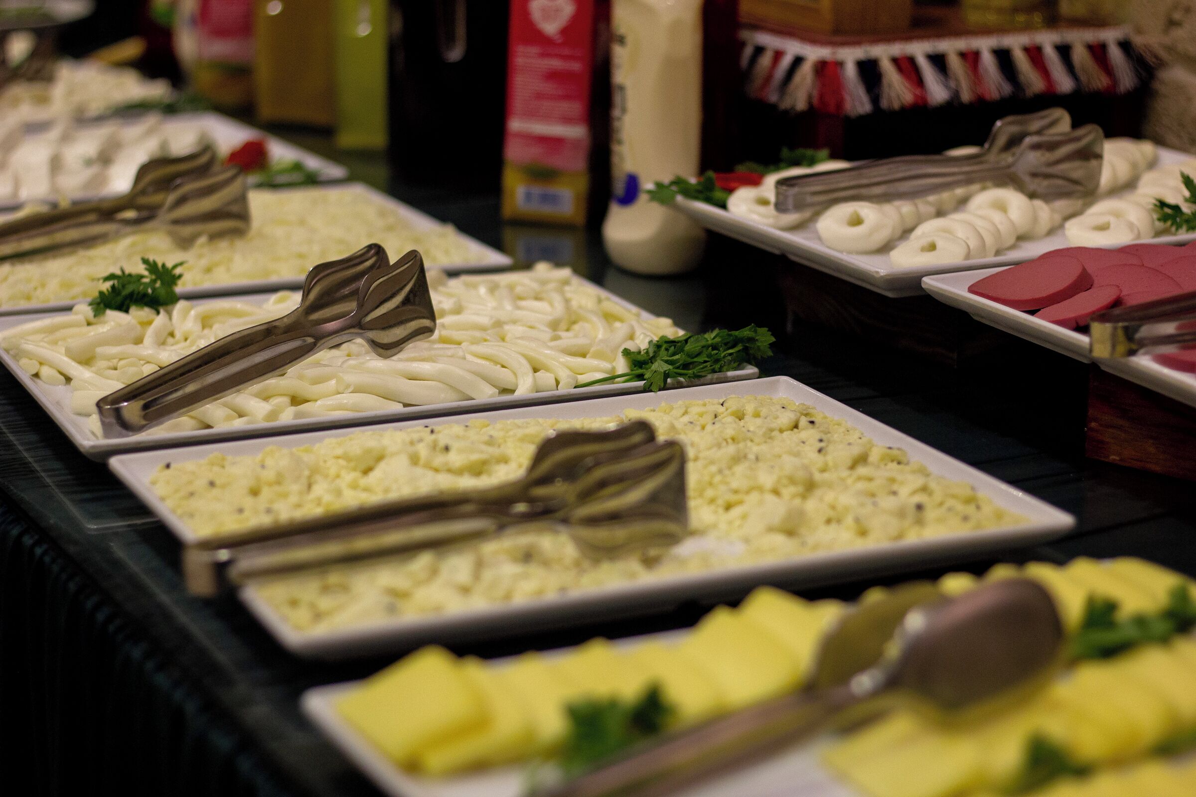 A buffet with various food items including pasta, mashed potatoes, and other dishes.