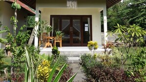 A two-story building with a red-tiled roof and a sign that reads "MALIBU". - Bali Fab Dive Center - Hostel (Karangasem)