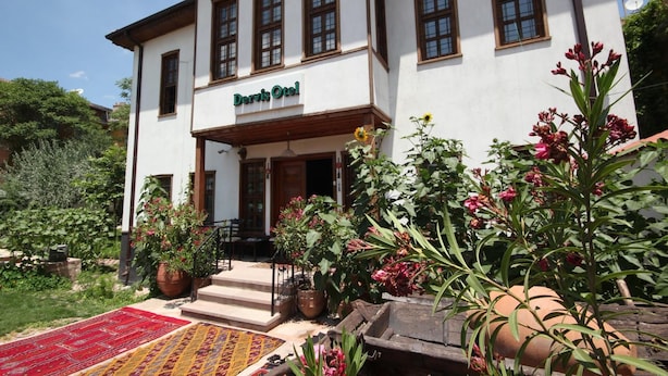 A two-story building with a sign reading "Boris Oto." - Konya Dervish Hotel (Konya)