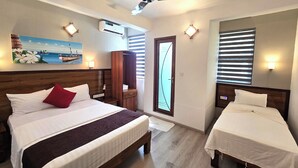 A hotel room with two beds, a ceiling fan, an air conditioning unit, a painting, and a window with blinds. - Tropic Tree Hotel Maldives (Gulhi)