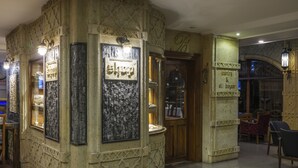 A stone-walled interior with a jewelry display and a sign reading "old bazaar". - Balikcilar Hotel (Konya)