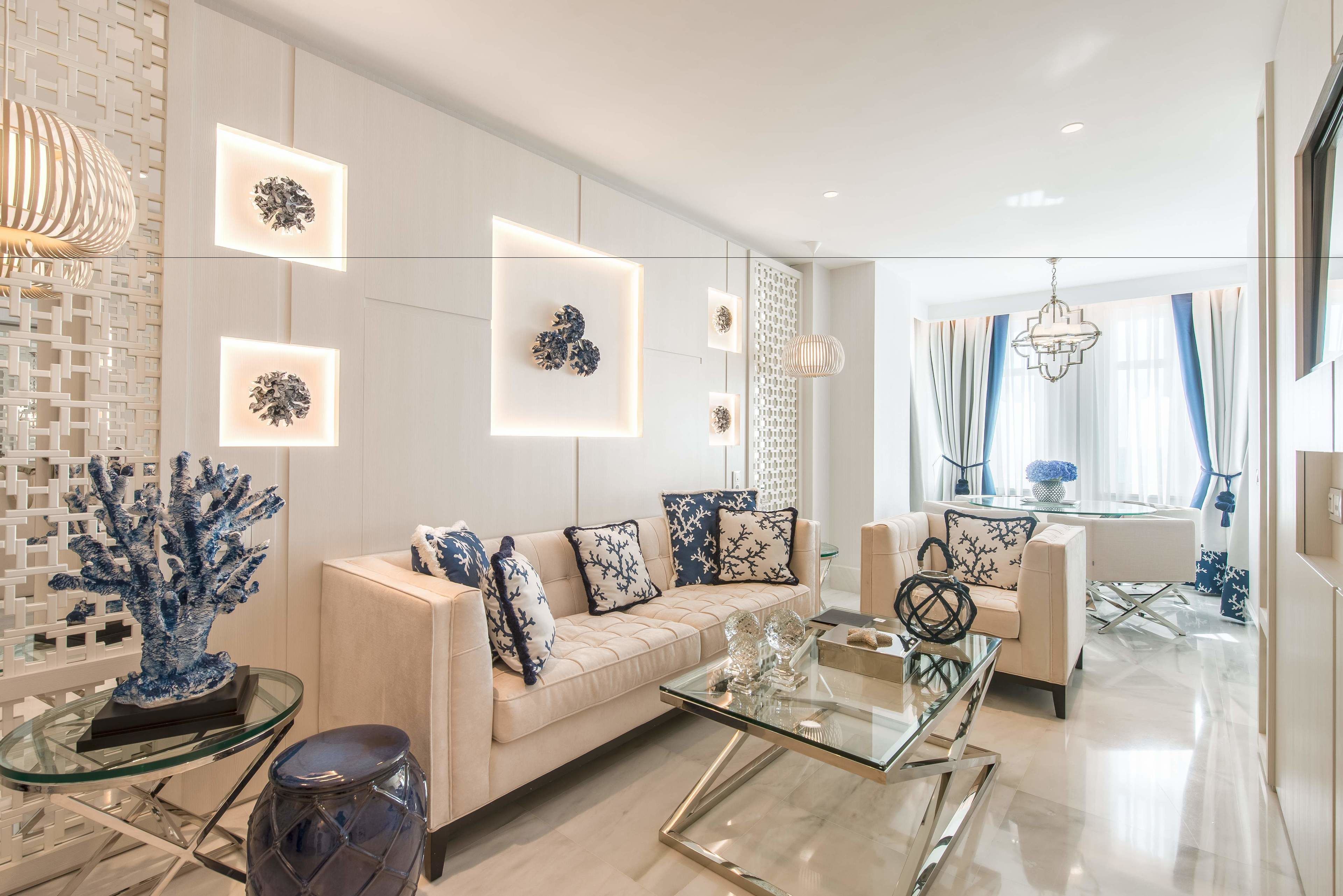 A modern living room with a sofa, coffee table, and decorative items.
